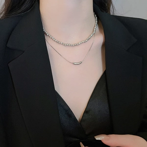 Silver geometric double-layered pearl necklace shown on model with minimalist style