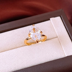 Macro view of a sparkling oval-cut cubic zirconia ring in a gold plated setting.