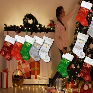 Close-up of festive Christmas stockings with Merry Christmas print and holly leaf patterns