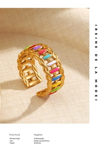 Detail of golden adjustable ring with colorful enamel inlay and chain texture finish