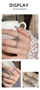 Detail of silver pearl ring set with zircon accents on a lifestyle background