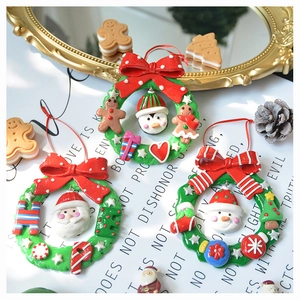 Three-piece Christmas wreaths set featuring Santa Claus, Snowman and Penguin figurines