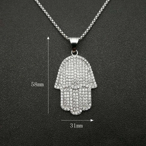 Macro detail of iced-out Hamsa Hand pendant measuring 58mm by 31mm with box chain