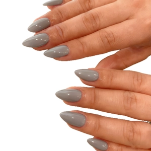 Glossy grey almond shaped press-on nails with minimalist Morandi finish on white background