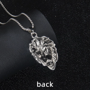 Rear view of silver lion head pendant in stainless steel on a professional black base
