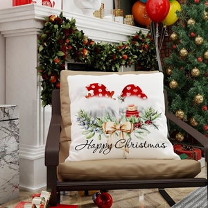 Christmas pillow cover with festive gnome and Happy Christmas text on leather chair