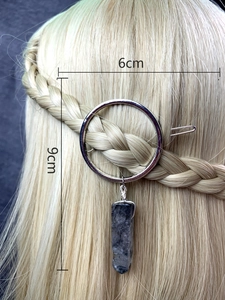 Detail of silver circular hair clip with dark crystal pendant and 9cm size dimensions