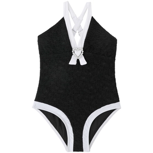 Detail of girls one-piece swimsuit with pearl heart buckle and lace texture