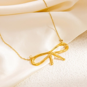 Detailed macro shot of a sleek 18k gold butterfly pendant on a polished link chain