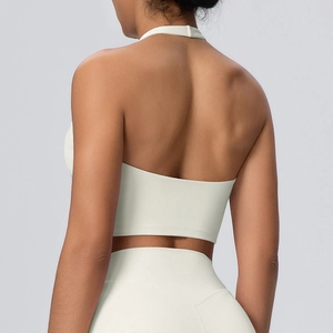 Dettaglio del reggiseno sportivo allacciato al collo color crema con schiena scoperta