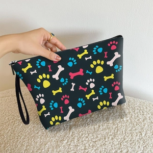 Portable dog bone print makeup bag with colorful paw patterns and wrist strap