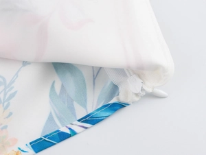 Macro shot of a high-quality hidden zipper closure on floral print fabric set