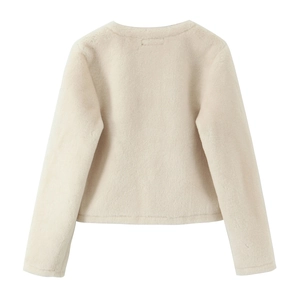 Close-up of the plush faux fur texture and knot buckle detail on a beige cropped jacket