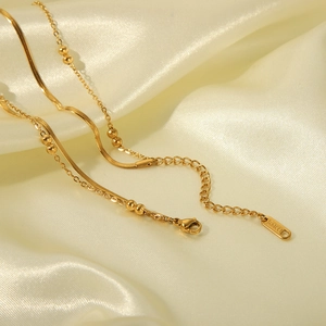 Collana a doppio strato in acciaio inossidabile dorato con catena a serpente e perline