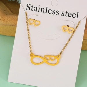 Detailed view of golden stainless steel jewelry set featuring infinity and heart designs