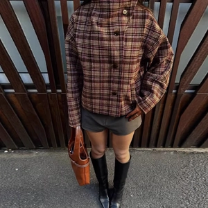 Chic women's plaid cropped jacket with stand collar paired with high boots and shorts