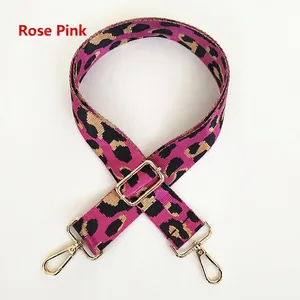 Detail of rose pink leopard print bag strap with polished gold metal swivel hooks
