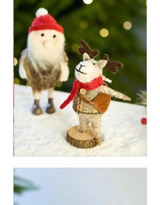 Handmade wool felt reindeer figure with red scarf on wooden base for Christmas decor