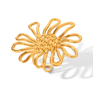 Macro shot of gold stainless steel sunflower ring with detailed petal textures and open band