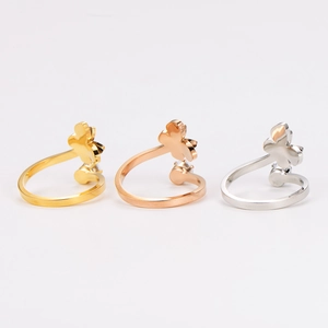 Detailed view of three butterfly rings in gold, rose gold and silver finishes