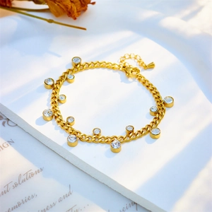 Elegant gold titanium bracelet featuring round zircon charms and a classic link design