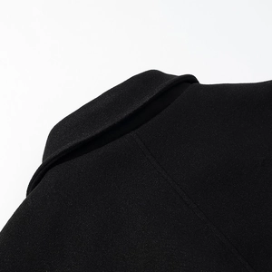Close-up of black woolen coat collar showing detailed stitching and premium fabric texture