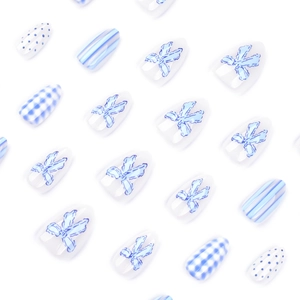 Blue bow almond press-on nails with checkered and striped patterns on white background