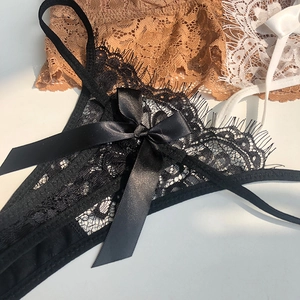 Close-up of black eyelash lace panties with delicate satin bow detail and floral mesh