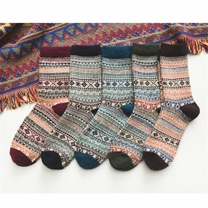 Detailed knit texture of five pairs of thick wool socks with ethnic geometric patterns