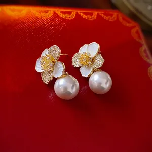 French style gold flower earrings with white pearl drop on red luxury jewelry box