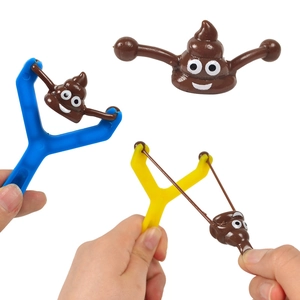 Creative slingshot toy set featuring brown poop emoji projectiles with blue and yellow handles