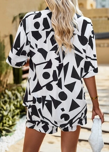 Back view of a woman in a black and white geometric print shirt and shorts set outdoors