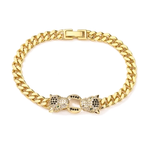 Close-up of gold Cuban chain bracelet with leopard heads set with sparkling zircons