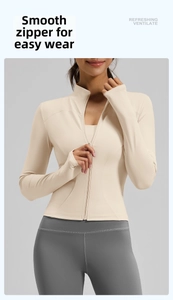 Close-up of smooth front zipper and stand collar on beige yoga jacket for women
