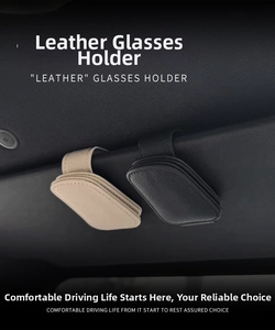 Close-up of black and beige textured leather car visor clips for sunglasses storage