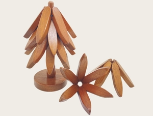 Macro shot of a wooden tree-shaped heat insulation pad with detachable leaf coasters