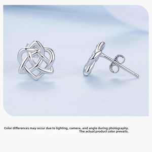 Macro view of silver S925 sterling silver Celtic knot and heart hollow stud earrings