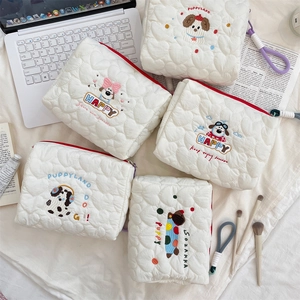 Detailed view of quilted makeup bag with cute dog embroidery and zipper lanyard