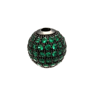 Detailed macro view of a round micro-pave bead with vibrant green crystals and a central hole