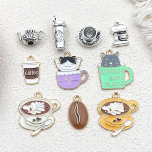 Detailed close-up of colorful enamel coffee tea charms with intricate cafe latte art patterns