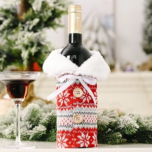 Detail of red knit wine bottle cover with snowflake pattern and white faux fur collar