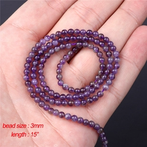 Close-up of 3mm natural purple amethyst round beads on a 15-inch strand for jewelry DIY