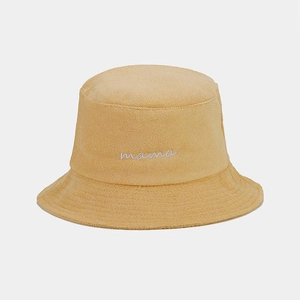 Detail of yellow terry cloth bucket hat with white mama script embroidery