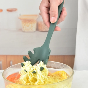 Dark green silicone pasta server with drainage holes and claw design for noodles