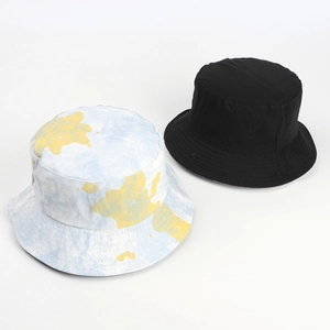 Detail showing colorful tie-dye patterns and solid black reversible cotton bucket hats