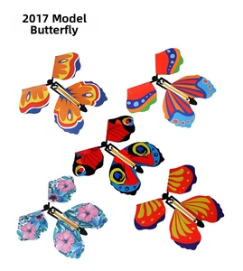 Detail of five colorful wind-up flying butterfly toys with various printed wing patterns