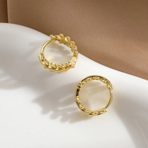 Golden olive leaf hoop earrings with a minimalist circular design and metallic finish
