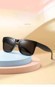 Detailed view of black thick frame children's sunglasses on geometric display stands