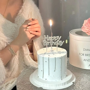 Elegant birthday cake topper with Happy Birthday sign and silver bead chain decoration