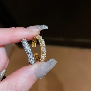 Macro shot of gold and silver plated hoop earrings with shimmering pave-set crystals